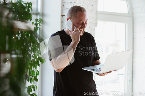 Image of Young man studying at home during online courses for designers, consultants, IT-managers