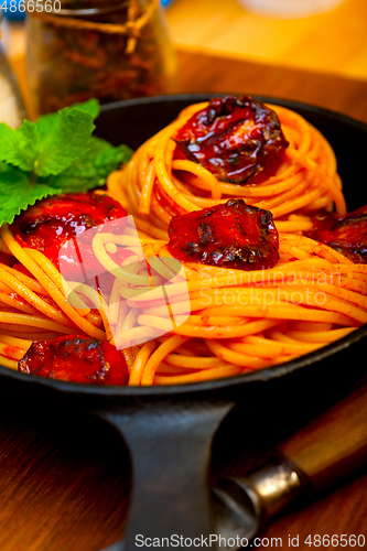 Image of italian spaghetti pasta and tomato with mint leaves