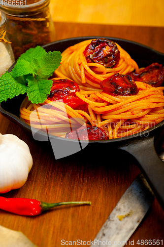 Image of italian spaghetti pasta and tomato with mint leaves