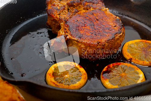 Image of pork chop seared on iron skillet