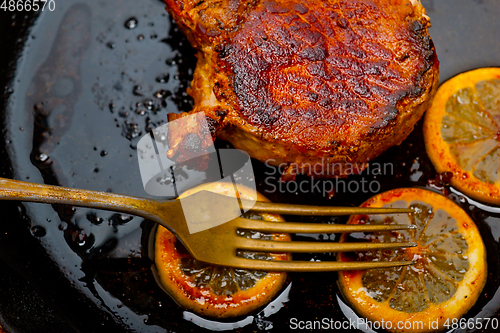 Image of pork chop seared on iron skillet