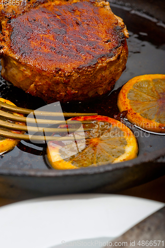 Image of pork chop seared on iron skillet