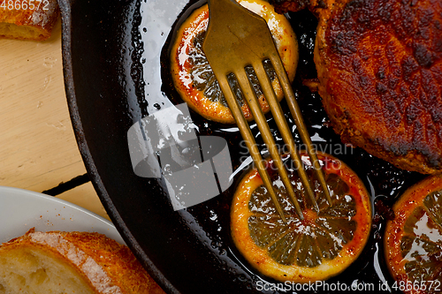 Image of pork chop seared on iron skillet