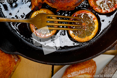 Image of pork chop seared on iron skillet