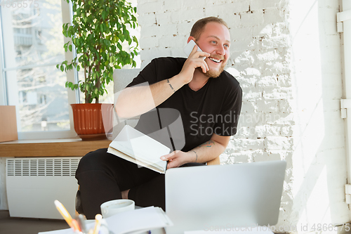 Image of Young man studying at home during online courses for managers, marketers, buyers