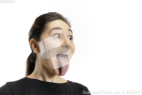 Image of Smiling girl opening her mouth and showing the long big giant tongue isolated on white background, crazy and attracted