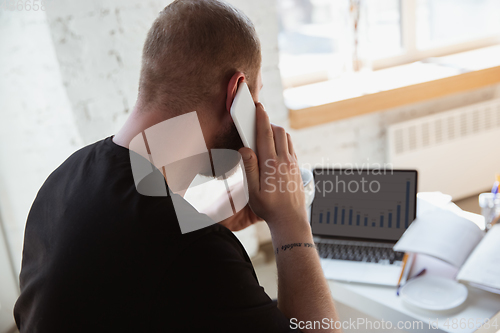 Image of Young man studying at home during online courses for analytics, financists, economists