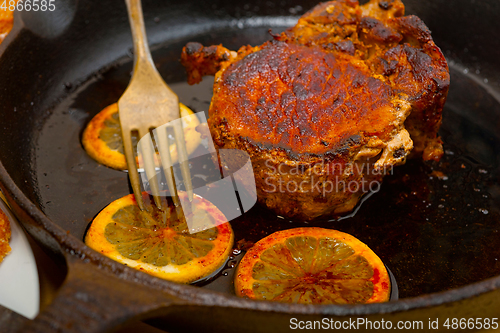 Image of pork chop seared on iron skillet