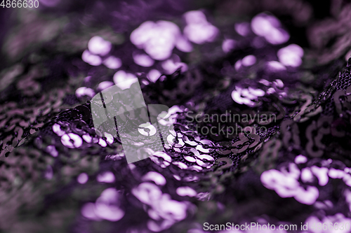 Image of shimmering violet fabric with sequins background