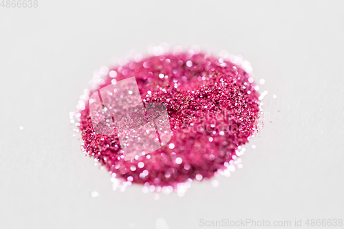 Image of pink glitters on white background