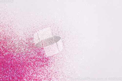 Image of pink glitters on white background