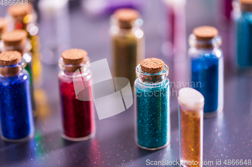 Image of set of different color glitters in bottles