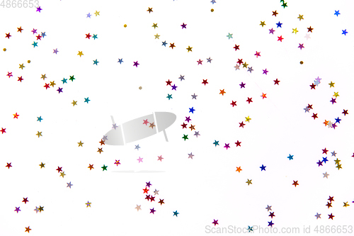 Image of star shaped glitters on white background