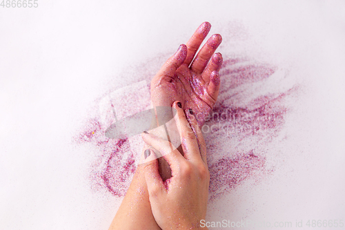 Image of hands with glitters on white background