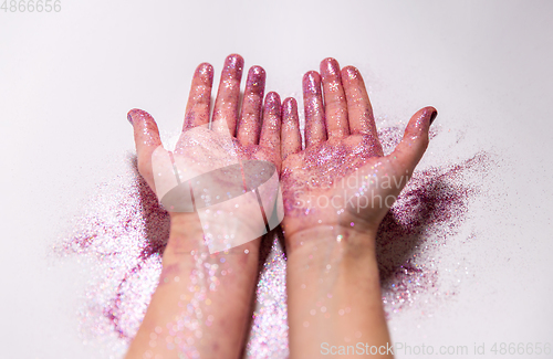 Image of hands with glitters on white background