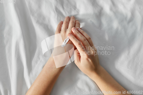 Image of woman applying hand cream at home