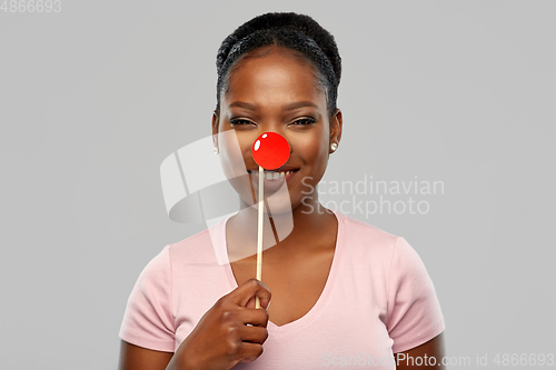 Image of happy african american woman with red clown nose