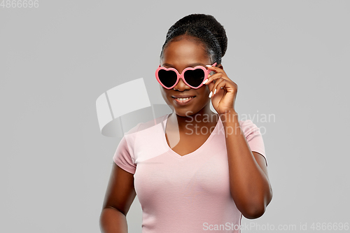 Image of african american woman in heart-shaped sunglasses
