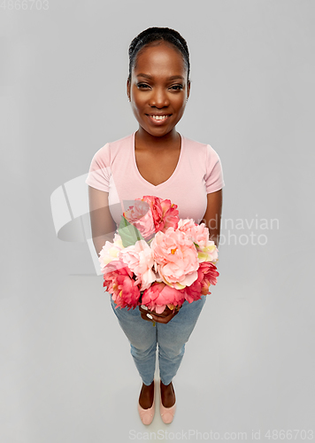 Image of happy african american woman with bunch of flowers