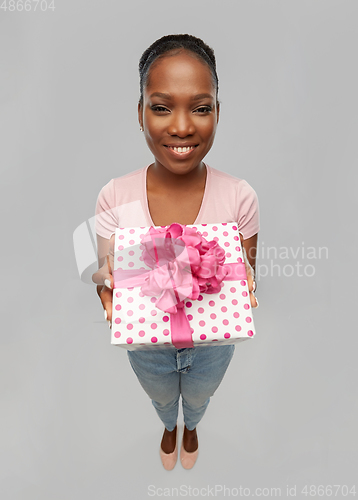 Image of happy african american woman with gift box