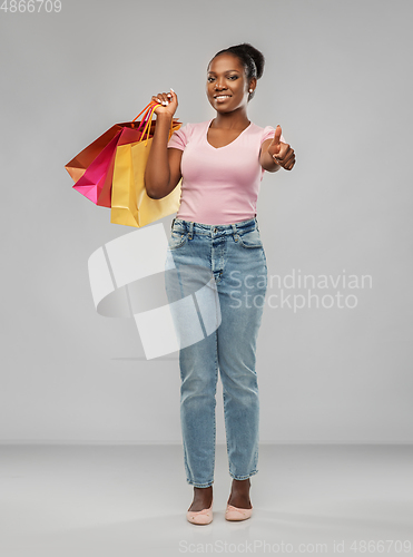 Image of happy african american woman with shopping bags