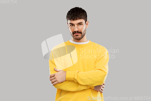 Image of young man in glasses and yellow sweatshirt