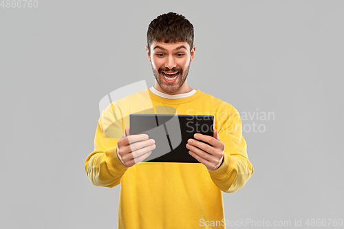 Image of smiling young man with tablet pc computer