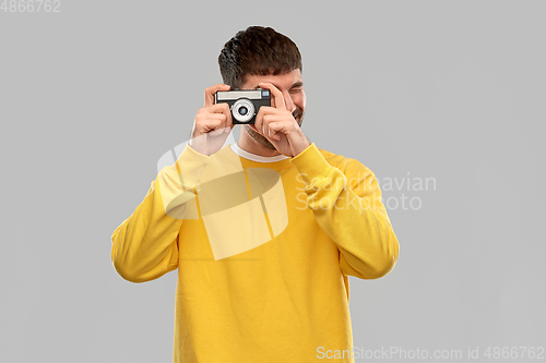 Image of young man with vintage film camera