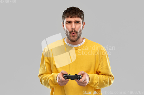 Image of man or gamer with gamepad playing video game