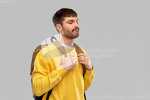 Image of sad unhappy young man with backpack