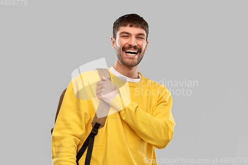 Image of happy smiling young man with backpack