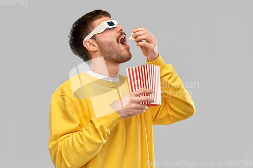 Image of man 3d movie glasses eating popcorn