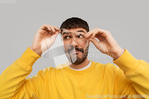 Image of goofy young man in glasses and yellow sweatshirt