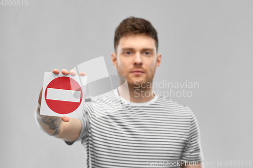 Image of young man showing stop sign