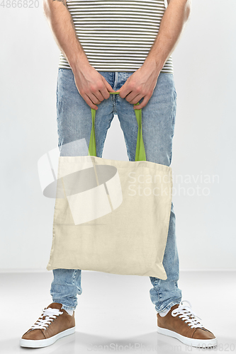 Image of man with reusable canvas bag for food shopping