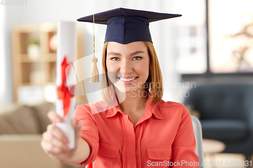 Image of graduate student woman with diploma at home
