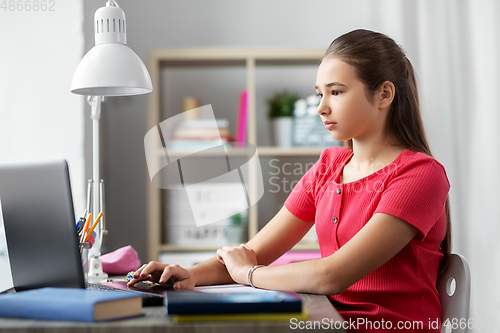 Image of student girl with laptop computer learning at home