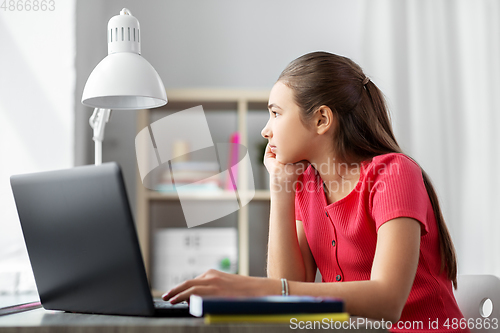 Image of student girl with laptop computer learning at home