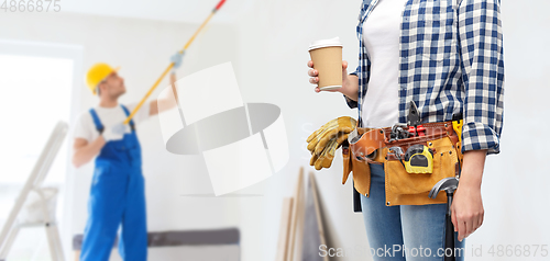 Image of woman with takeaway coffee cup and working tools