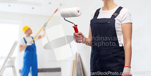 Image of close up of painter or builder with paint roller