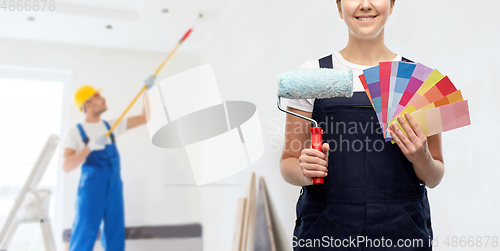 Image of close up of painter with roller and color charts