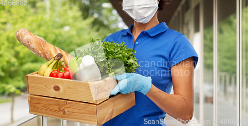 Image of delivery woman in face mask with food in box