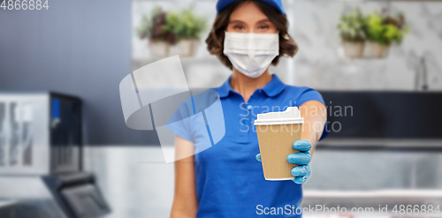 Image of saleswoman in face mask with takeaway coffee cup