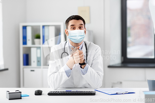 Image of male doctor having video conference at hospital