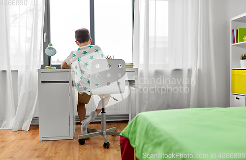 Image of boy sitting at table at home