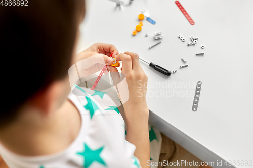 Image of little boy playing with airplane toy at home