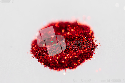 Image of red glitters on white background