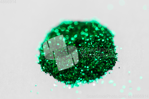 Image of green glitters on white background