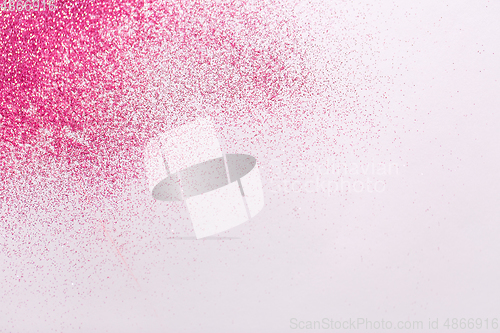 Image of pink glitters on white background