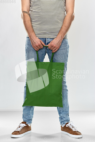 Image of man with reusable canvas bag for food shopping